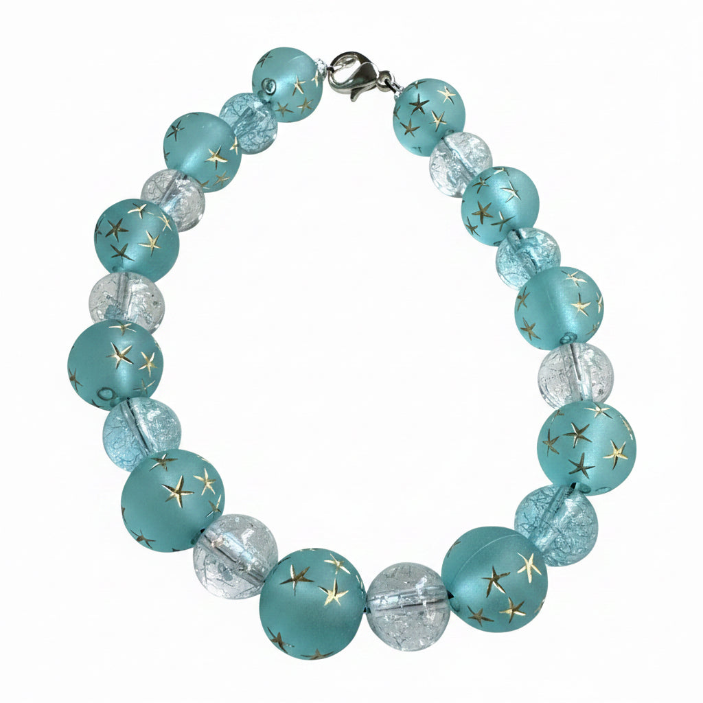 Starfall Constellations celestial bracelet featuring frosted aqua-blue star beads, sparkling crystal accents, and silver spacers displayed on a white background.