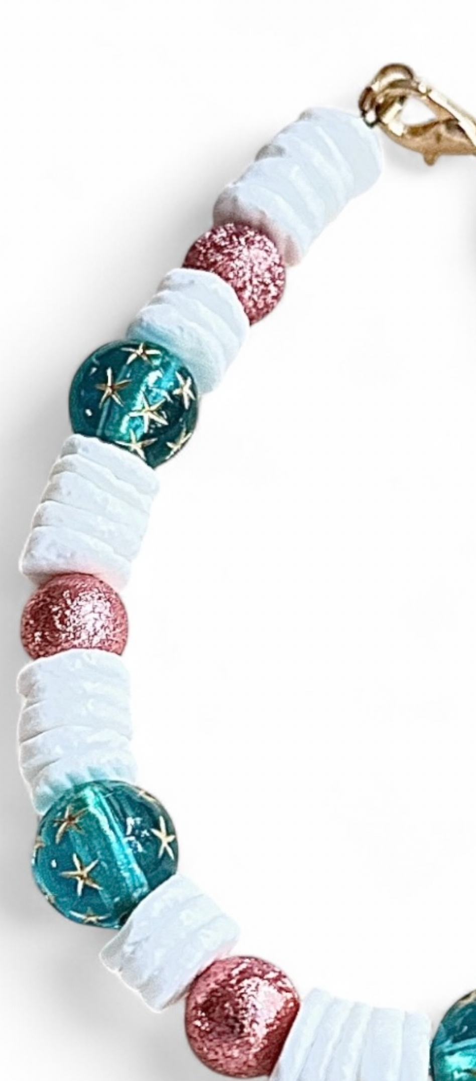 Handmade whimsical bracelet with teal galaxy beads, pink shimmer accents, and coastal-inspired details