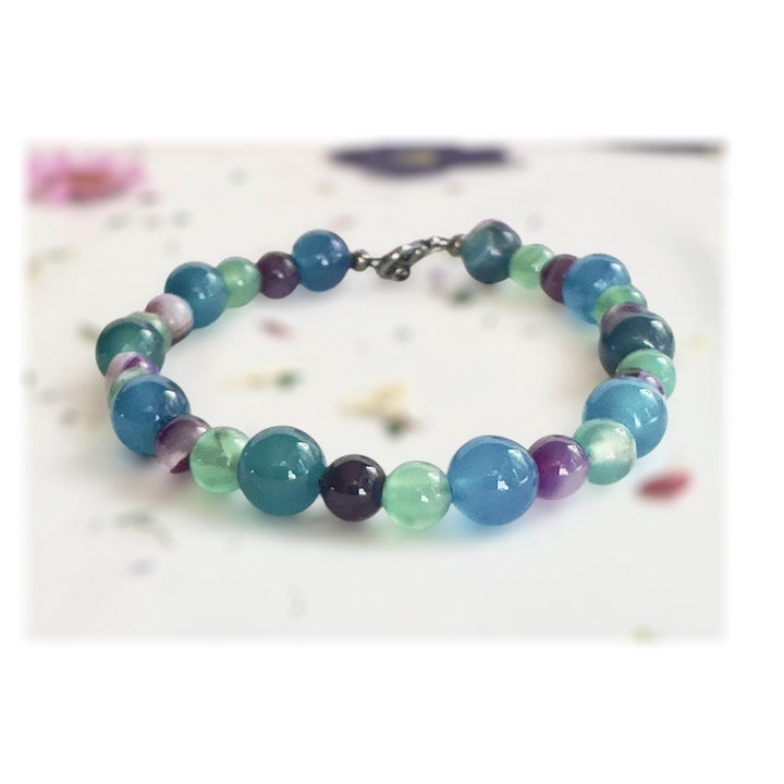     Close-up of the Summertide Dreams gemstone bracelet highlighting blue, aqua, green, and purple beads.