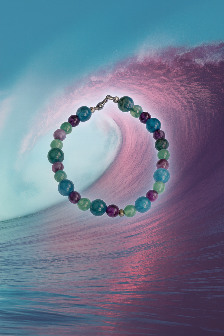     Summertide Dreams bracelet displayed on an artistic ocean wave background.