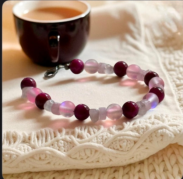Together in Pink ・ Held in Hope new bracelet with glass and magenta Tiger’s Eye on a cozy knitted background.