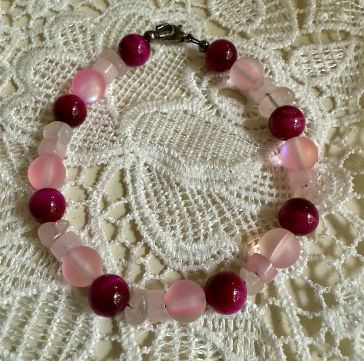 new bracelet Together in Pink ・ Held in Hope featuring glass, magenta Tiger’s Eye, and Rose Quartz.
