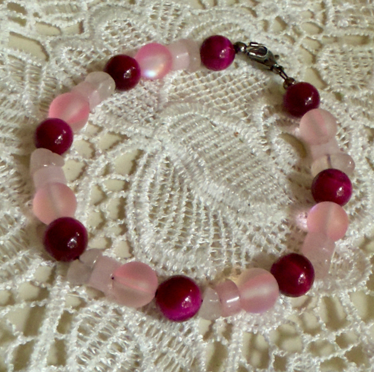 Together in Pink ・ Held in Hope new bracelet featuring glass and magenta Tiger’s Eye beads for breast cancer awareness.