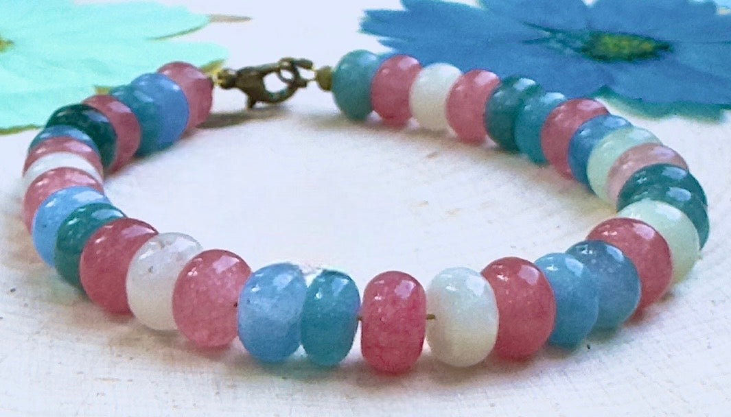 Close-up view of pastel blue, white, and pink beads highlighting the craftsmanship and colors of the Trans Pride bracelet.
