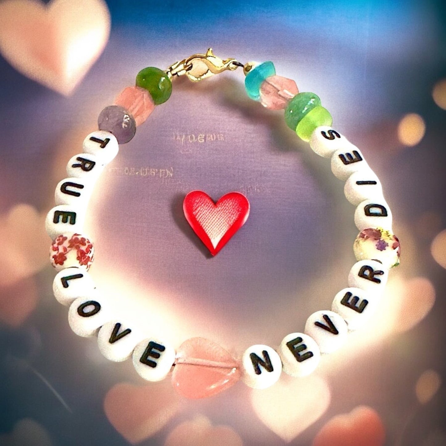 Bracelet with colorful beads and a red heart charm on a blurred background