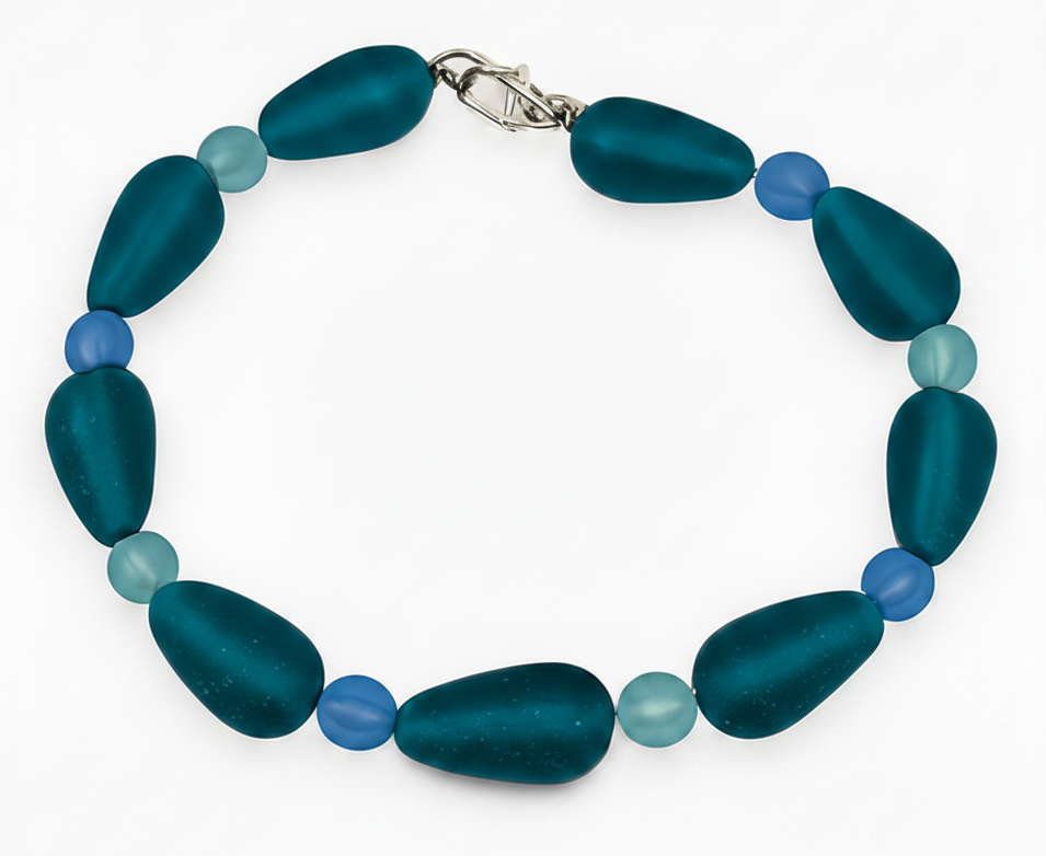 Teal blue handmade beaded bracelet with frosted glass beads and silver clasp on white background