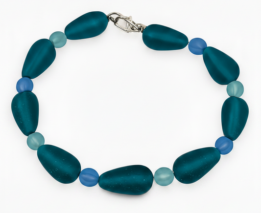 Teal blue handmade beaded bracelet with frosted glass beads and silver clasp on white background