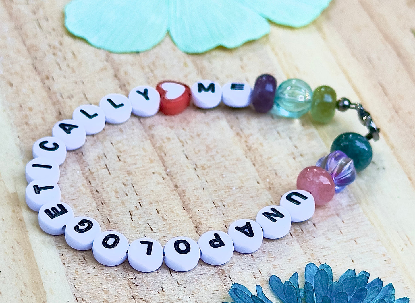 Unapologetically Me bracelet flat lay soft aesthetic floral background
