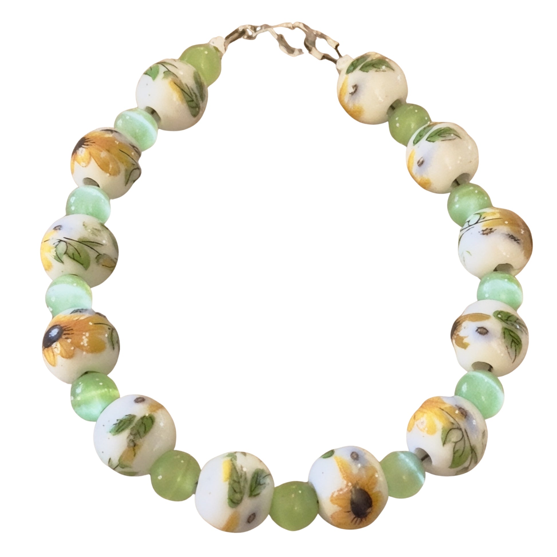 Handmade sunflower garden bracelet featuring porcelain sunflower beads and soft green accent beads on a white background.