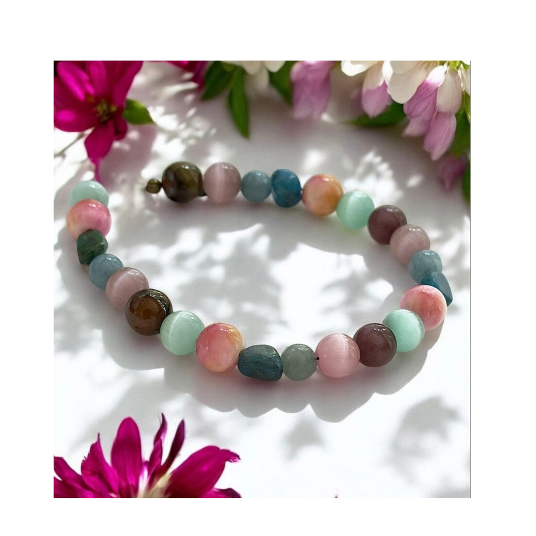 Treasures of the Willow Cove beaded bracelet surrounded by soft flowers and natural light in a dreamy garden-inspired setting.