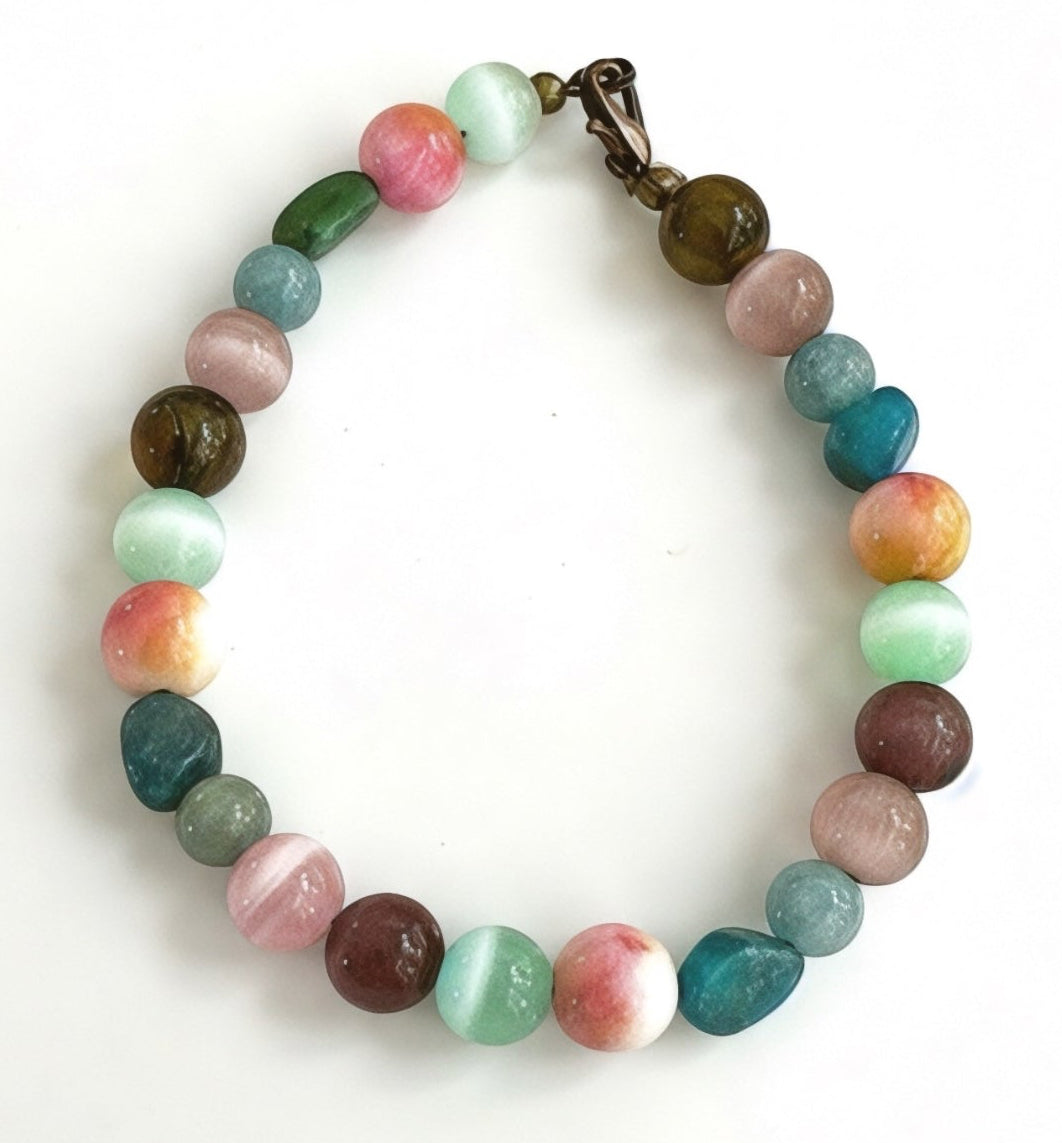 Full view of the Treasures of the Willow Cove beaded bracelet featuring colorful earth and ocean-inspired gemstone beads and an antique-style clasp on a white background.