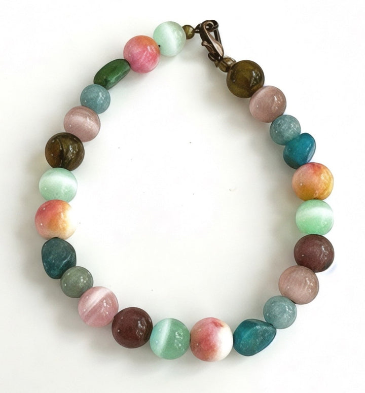 Full view of the Treasures of the Willow Cove beaded bracelet featuring colorful earth and ocean-inspired gemstone beads and an antique-style clasp on a white background.