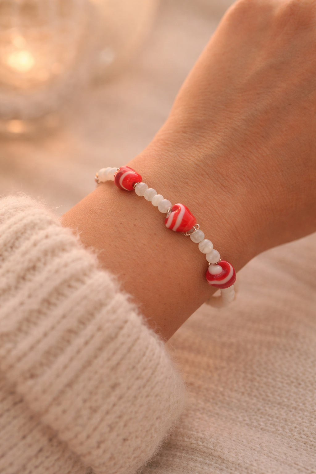 Handmade heart bead bracelet for women worn on wrist, romantic red and white glass jewelry gift.